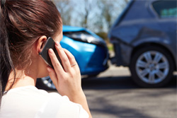 Woman phone in front of car accident